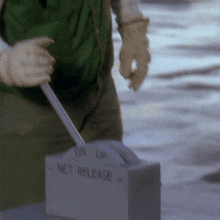a person is holding a switch that says " net release "