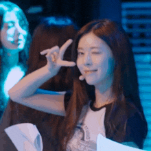 a woman making a peace sign with her hand