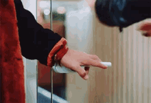 a close up of a person 's hand holding a door knob