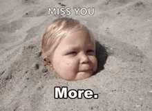 a baby is buried in the sand with his head sticking out of the sand .