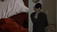 a man covering his face with his hand next to a woman laying on a bed