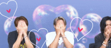 three men covering their faces with their hands in front of bubbles with hearts drawn on them
