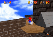 a video game screen shows a brick wall and a pyramid with the number 10 in orange