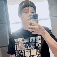 a young man is taking a picture of himself in a mirror with his phone .