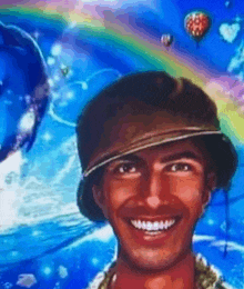 a man in a hat is smiling in front of a painting of a dolphin and hot air balloons .