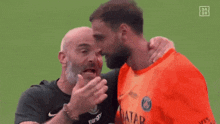a man is kissing another man on the cheek .
