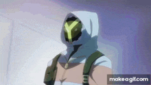 a man in a hoodie with a yellow y on his face is walking down a hallway .