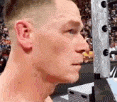a close up of a man 's face in front of a crowd .