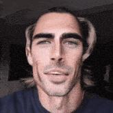 a close up of a man 's face with his tongue sticking out