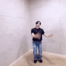 a man wearing a mask is dancing in a room with a white wall .