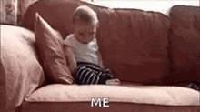 a baby is sitting on a couch holding a cell phone and saying `` me '' .