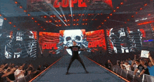 a man stands in front of a large screen that says cop