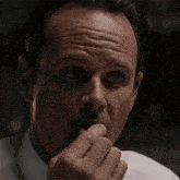 a close up of a man 's face with a surprised look on his face