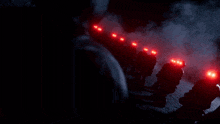 a row of soldiers with red lights on their faces