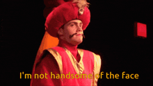 a man in a red and gold costume says i 'm not handsome of the face