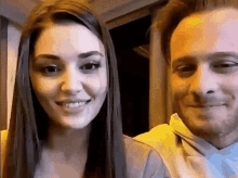 a man and a woman are smiling at each other .