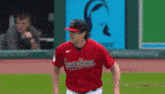 a baseball player wearing a red uniform with the word indiana on it