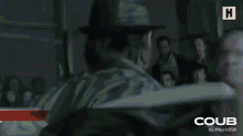 two men are standing next to each other in a room with the word coub on the bottom right