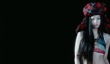 a blurry image of a woman in a plaid shirt and shorts