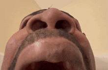 a close up of a man 's face with his mouth wide open