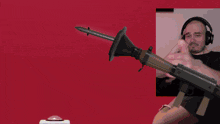 a man is holding a gun in front of an explosion and the word cut is on the red background