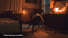 a poster for the conjuring last rites shows a woman doing push ups