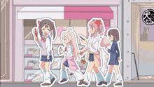 a group of girls walking in front of a store with a sign that says cafe