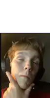 a young boy wearing headphones has his eyes closed