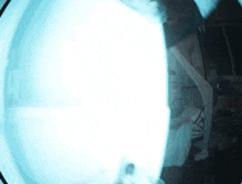 a blurry picture of a room with a light coming through the door