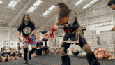 two wrestlers in a ring with one wearing a t-shirt that says ' sdp ' on it