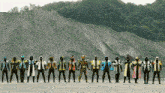 a group of masked superheros are lined up in a row