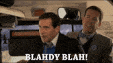 two men on a bus with blahdy blah written on the bottom right