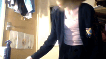 a woman in a school uniform with a badge that says x
