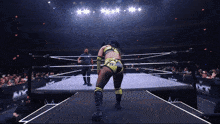 a female wrestler in a ring with the word nxt on the side