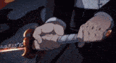 a person in a suit is holding a sword in their hand .