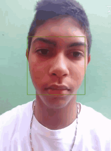 a young man 's face is shown with a green square around it