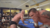 two men in a wrestling ring with a ggw logo on the bottom