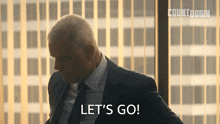 a man in a suit is saying let 's go