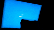 a blue light is shining on a dark background