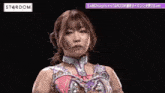 a woman in a wrestling costume is dancing on a stage in a dark room .