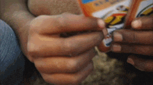 a close up of a person 's hands holding a bag that says ' 2 ' on it