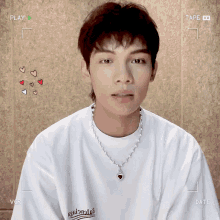 a young man wearing a balenciaga shirt is being recorded on a video camera