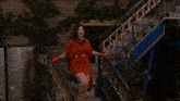 a woman in a red dress and red gloves says " the rachel reilly "
