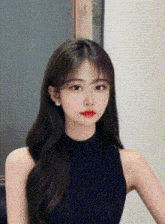 a young woman with long hair is wearing a black tank top .