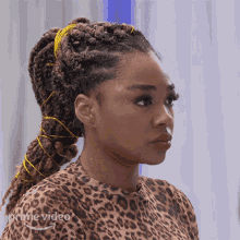 a woman is wearing a leopard print shirt with the word prime video on it