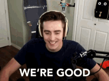 a man wearing headphones is smiling and says we 're good