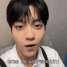 a close up of a person 's face with the words `` eres de val ? soobin '' written above it .