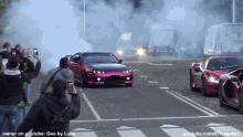 a group of people are taking pictures of a purple car and a red car