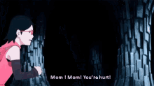 a woman in a pink shirt is standing in a cave and talking to her mother .