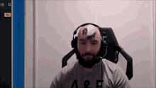 a man wearing headphones and a shirt that says a & f on it